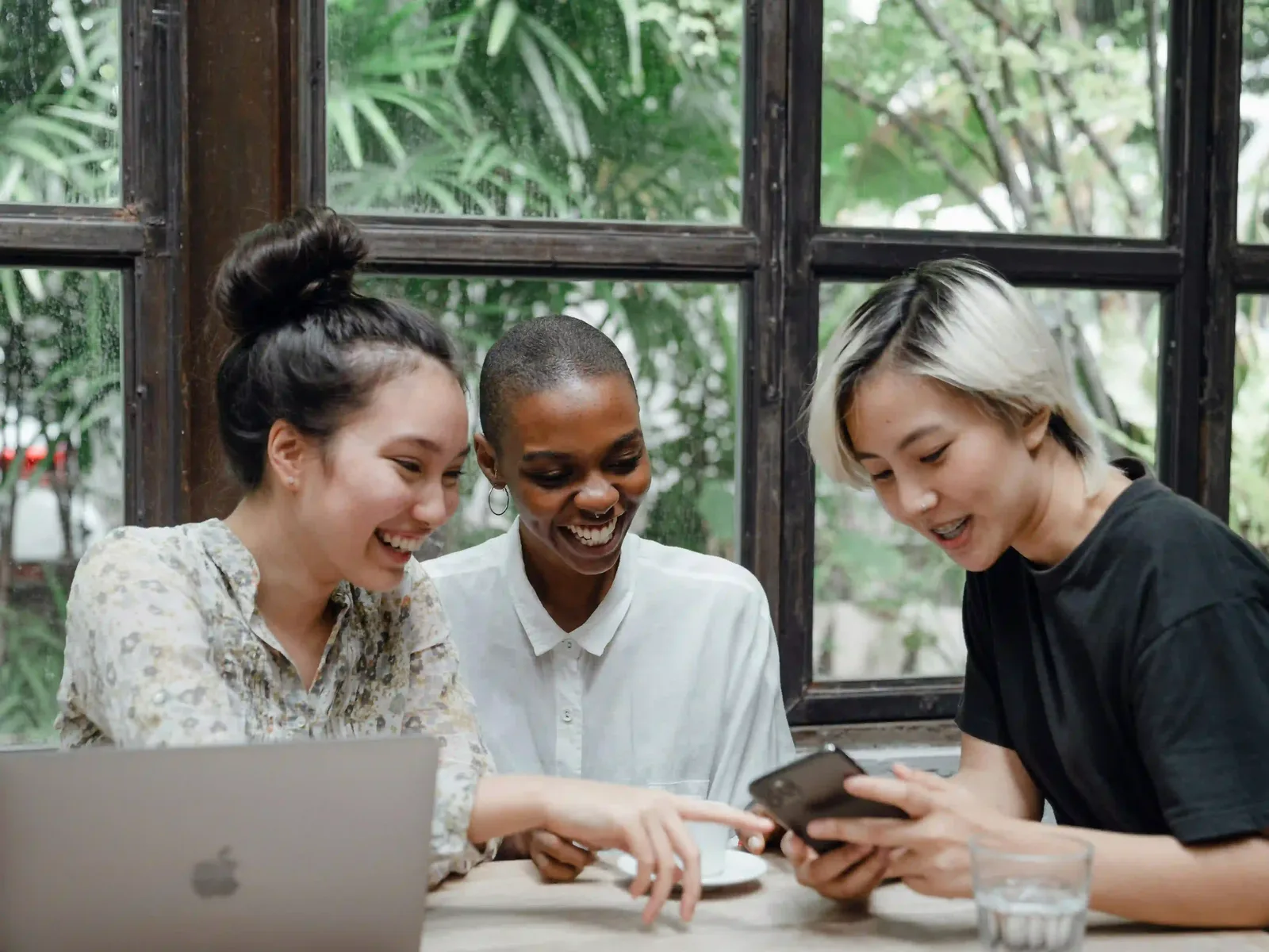 Colleagues reviewing social media content on a phone